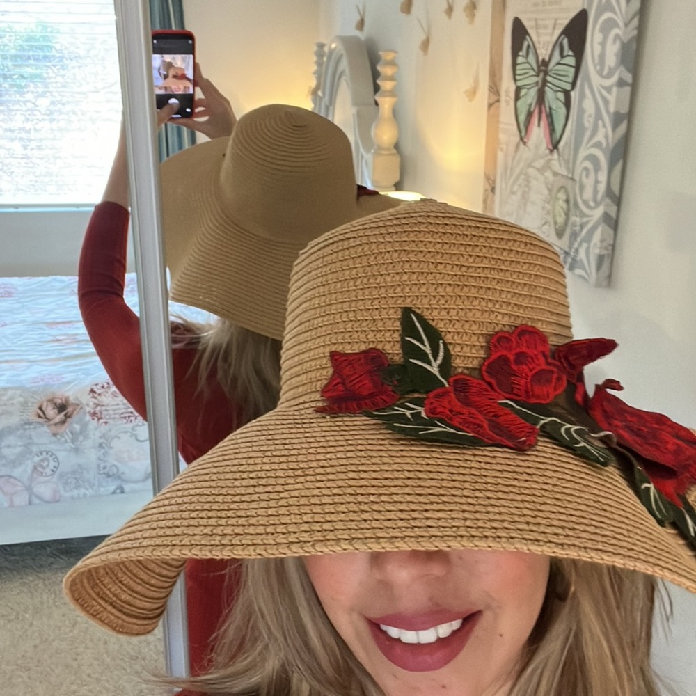 Beautiful sun hat with red roses appliqué. Very lightly worn.